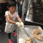 child grilling chicken