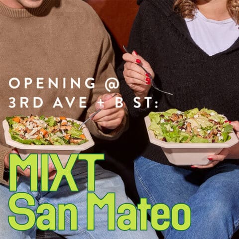 A man and a woman eating salad